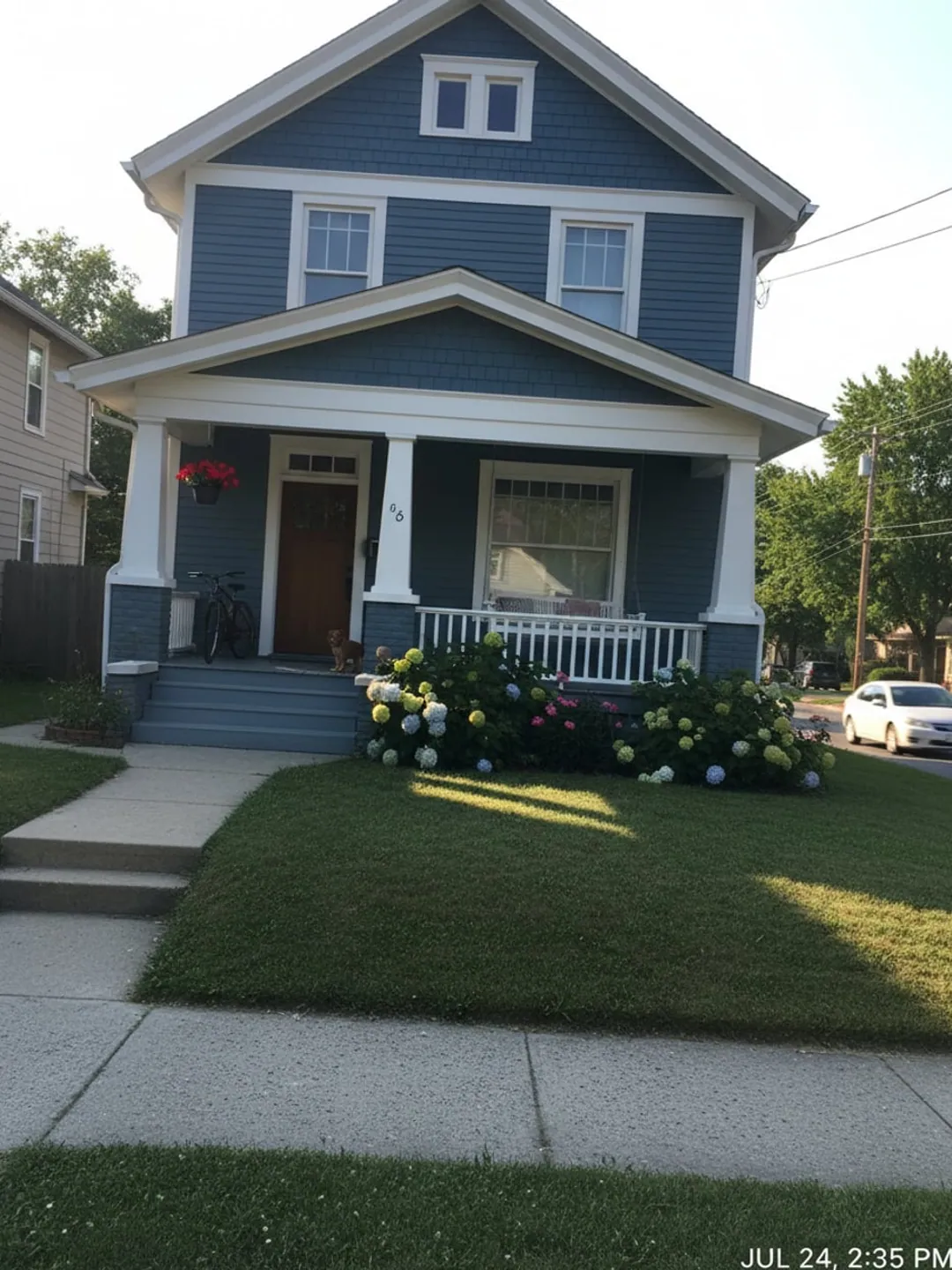 A photograph of a craftsman bungalow taken from the pavement.